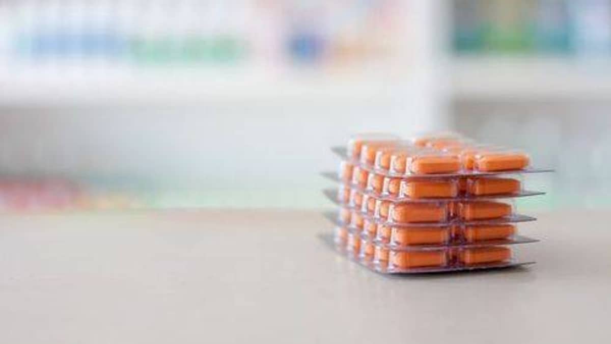 Medications organized in labeled adherence packaging with prescription bottles
