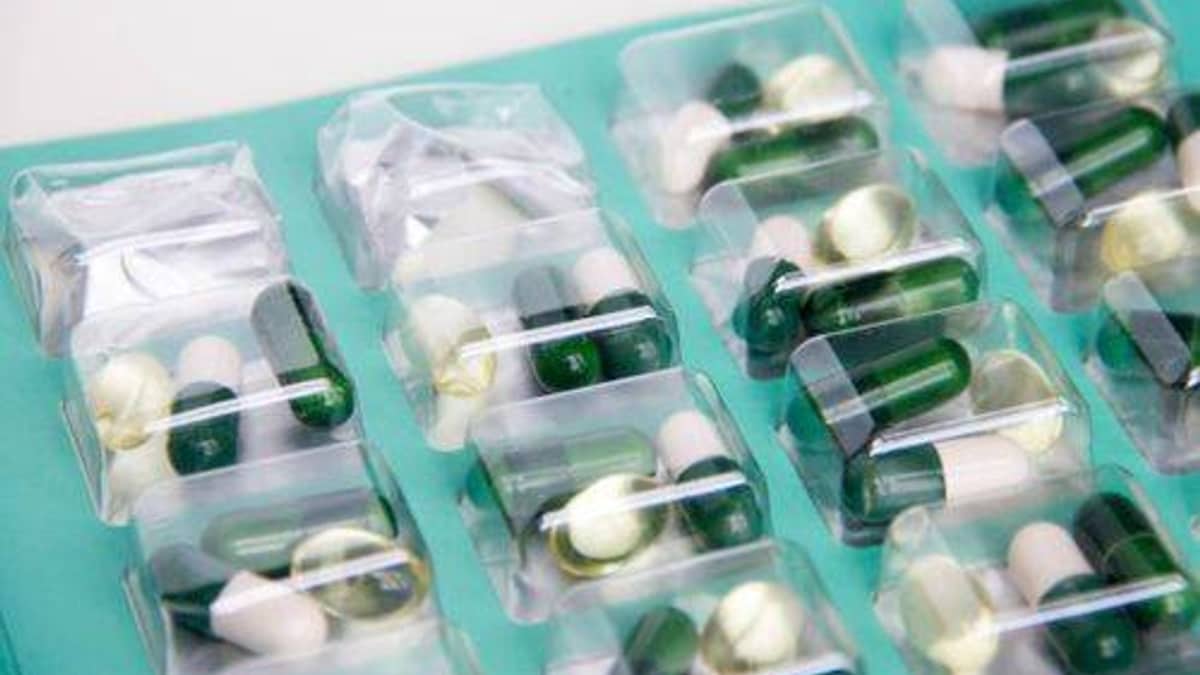 Multi-dose blister packs of medication stacked on a pharmacy counter