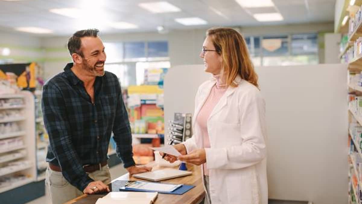 Pharmacist reviewing medications one-on-one with a patient
